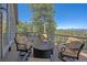 Open-air deck area features mountain views, a fire pit and four chairs, perfect for enjoying the great outdoors at 22683 Hagler Dr, Golden, CO 80401