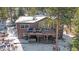 Home featuring expansive windows, large deck, mountain views, and snow-covered landscaping at 22683 Hagler Dr, Golden, CO 80401