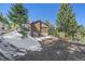 Exterior shot of home and garage, showcasing the driveway and surrounding trees at 22683 Hagler Dr, Golden, CO 80401