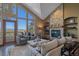 Cozy living room with a stone fireplace, comfortable seating, and picturesque mountain views at 22683 Hagler Dr, Golden, CO 80401