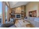 Cozy living room with stone fireplace and backyard views at 22683 Hagler Dr, Golden, CO 80401