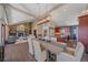 Open-concept living room with stone fireplace and dining area with modern light fixture at 22683 Hagler Dr, Golden, CO 80401