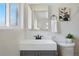 Bright bathroom featuring a sleek white sink with modern fixtures and stylish decorative accents at 12345 W 32Nd Ave, Wheat Ridge, CO 80033