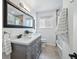 Stylish bathroom with double sinks, modern fixtures, and a large framed mirror at 12345 W 32Nd Ave, Wheat Ridge, CO 80033