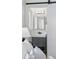 En suite bathroom featuring a modern vanity with storage and a sliding barn door, seen from the bedroom at 12345 W 32Nd Ave, Wheat Ridge, CO 80033