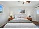 Bright bedroom featuring two windows and ambient bedside lighting creating a relaxing atmosphere at 12345 W 32Nd Ave, Wheat Ridge, CO 80033