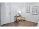 Inviting entryway showcasing hardwood floors, a console table with decor, and modern abstract artwork at 12345 W 32Nd Ave, Wheat Ridge, CO 80033