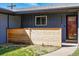 Charming covered front porch with a stylish wood screen and a glimpse of the front door at 12345 W 32Nd Ave, Wheat Ridge, CO 80033