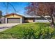 Charming single-story home featuring an attached garage and mature trees accenting the freshly mowed front lawn at 12345 W 32Nd Ave, Wheat Ridge, CO 80033