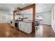 Bright, updated kitchen boasts stainless steel appliances, center island, and wood beam accents at 12345 W 32Nd Ave, Wheat Ridge, CO 80033
