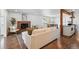 Inviting living room featuring a brick fireplace, white sofa, and seamless kitchen views at 12345 W 32Nd Ave, Wheat Ridge, CO 80033