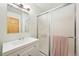 Clean bathroom featuring a vanity with a white countertop, and a shower with glass doors at 23558 Pondview Pl # B, Golden, CO 80401