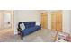Cozy bedroom featuring a comfortable futon, and closet space, perfect for relaxation and storage at 23558 Pondview Pl # B, Golden, CO 80401