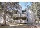 Multi-level exterior view surrounded by mature trees and partial view of the ground floor balcony at 23558 Pondview Pl # B, Golden, CO 80401