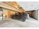 Attached garage with a car parked inside with an automatic door opener at 23558 Pondview Pl # B, Golden, CO 80401