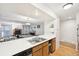 Open-concept kitchen with a breakfast bar overlooking the living area and cozy fireplace at 23558 Pondview Pl # B, Golden, CO 80401