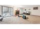 Comfortable living area features a fireplace, a sliding door to the patio, and carpet flooring at 23558 Pondview Pl # B, Golden, CO 80401