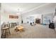 Spacious living room with a rustic fireplace, plush carpet, and abundant natural light at 23558 Pondview Pl # B, Golden, CO 80401