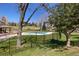 Fenced community pool and seating area with homes on a hillside in the background at 23558 Pondview Pl # B, Golden, CO 80401
