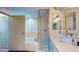 Elegant bathroom featuring a glass shower, a soaking tub, and marble counters at 1401 Wewatta St # 808, Denver, CO 80202