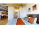 Comfortable bedroom featuring modern decor, ample natural light, and a view into a modern kitchen and living area at 1401 Wewatta St # 808, Denver, CO 80202