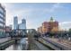 Panoramic city skyline view featuring modern architecture, bridges, and tranquil river settings at 1401 Wewatta St # 808, Denver, CO 80202