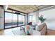 Sunlit living room featuring large windows with city views and comfortable seating, a perfect relaxation spot at 1401 Wewatta St # 808, Denver, CO 80202