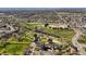 Aerial view showcasing a park, school, and the surrounding neighborhood at 9940 Pecos St, Thornton, CO 80260