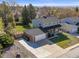 Scenic aerial view of a home showcasing its spacious yard, two-car garage, and proximity to trees at 9940 Pecos St, Thornton, CO 80260