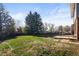 Large backyard with mature trees and a patio area, great for relaxation and outdoor activities at 9940 Pecos St, Thornton, CO 80260