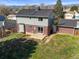 Back view of home with large lawn and mature trees at 9940 Pecos St, Thornton, CO 80260