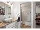Bathroom featuring white cabinets, granite countertops, large mirror and shower at 9940 Pecos St, Thornton, CO 80260
