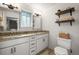 Bright bathroom with granite countertops, double sinks, and decorative shelves at 9940 Pecos St, Thornton, CO 80260
