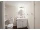 Well-lit half bathroom featuring a vanity with modern fixtures and wood-look floors at 9940 Pecos St, Thornton, CO 80260