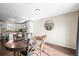 Dining room featuring wood table and floors, with a view of the kitchen at 9940 Pecos St, Thornton, CO 80260