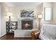 Close-up of a cozy fireplace with brick surround, decorative mantel, and wood floors at 9940 Pecos St, Thornton, CO 80260