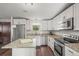 Bright kitchen featuring stainless appliances, granite countertops, an island and white cabinets at 9940 Pecos St, Thornton, CO 80260