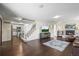 Open-concept living room with a view of the kitchen, a fireplace, and a staircase at 9940 Pecos St, Thornton, CO 80260