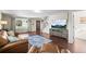 Spacious living room with wood floors, a large window, and a staircase leading to the upper level at 9940 Pecos St, Thornton, CO 80260