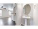Charming powder room with pedestal sink and decorative mirror at 12783 Leyden St # E, Thornton, CO 80602