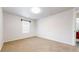 Bright bedroom with neutral walls, carpeted floors, and a large window offering lots of natural light at 12783 Leyden St # E, Thornton, CO 80602