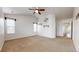 Spacious carpeted bedroom featuring a ceiling fan, neutral walls and decor, and two windows for natural light at 12783 Leyden St # E, Thornton, CO 80602