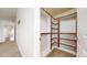 Walk-in closet with custom built-in wood shelving at 12783 Leyden St # E, Thornton, CO 80602