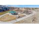 View of a green-roofed gazebo in a community park and recreation area near a pond and playground at 12783 Leyden St # E, Thornton, CO 80602