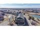 Aerial view of a multi-story townhouse complex with well-maintained landscaping and views of the surrounding neighborhood and cityscape at 12783 Leyden St # E, Thornton, CO 80602