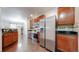 Updated kitchen with stainless steel appliances, dark countertops, and rich wood cabinets at 12783 Leyden St # E, Thornton, CO 80602