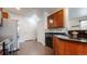 Modern kitchen features stainless steel appliances, dark countertops and cabinetry, and hardwood floors at 12783 Leyden St # E, Thornton, CO 80602