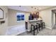 Finished basement bar featuring granite counters, barstools and a small refrigerator at 6614 Club Villa Rd, Parker, CO 80134