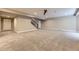 This is a large open basement area with carpet, recessed lighting, and stairs to the upper floors at 6614 Club Villa Rd, Parker, CO 80134