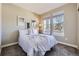 Bright bedroom features two windows, light grey walls and plush carpet at 6614 Club Villa Rd, Parker, CO 80134